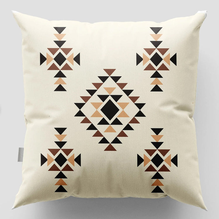Cream cushion cover with brown and black diamonds and small geometric motifs.