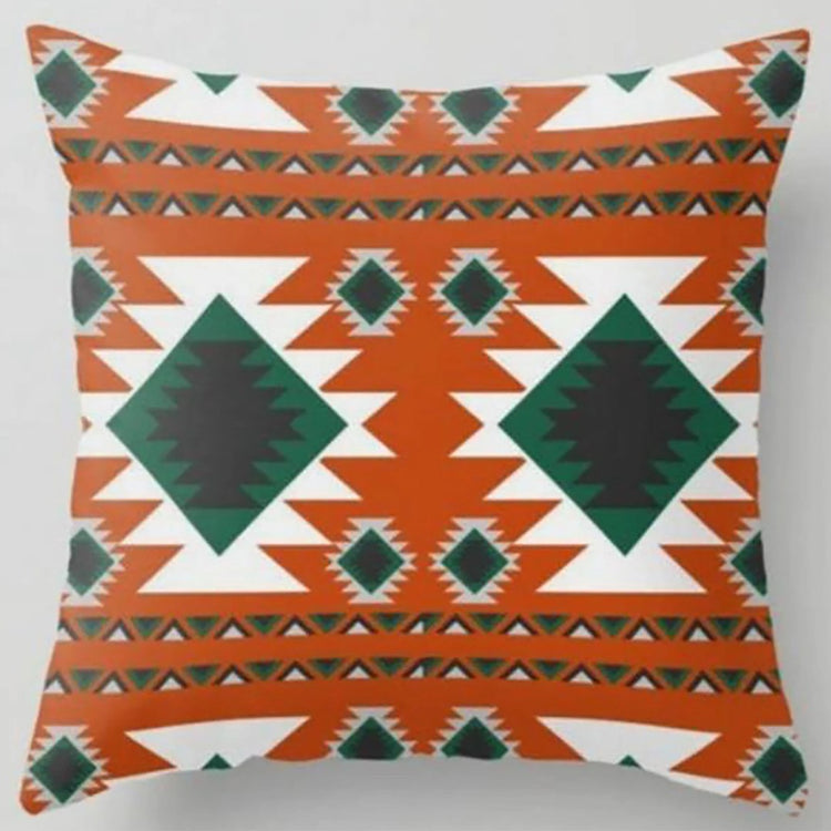 Orange cushion cover with dark green diamonds and white stepped geometric bands.