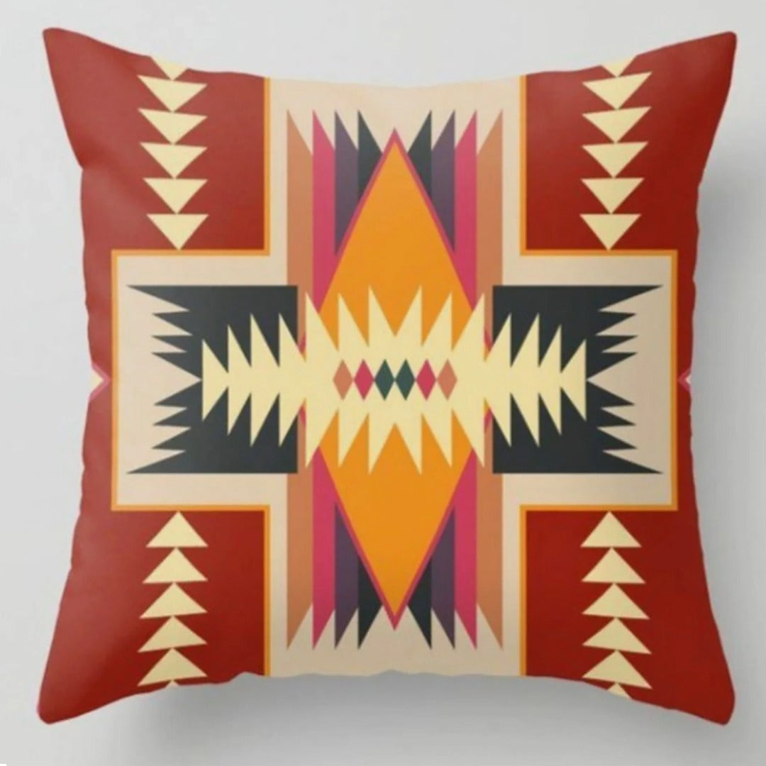 Rust cushion cover with a cream geometric cross and yellow, purple and black details.