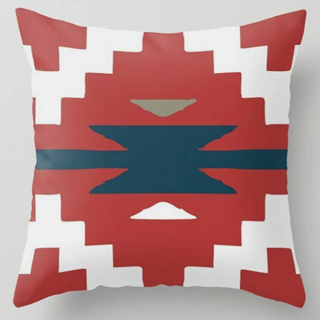 Cushion cover with a rust stepped diamond and dark teal centre on white.
