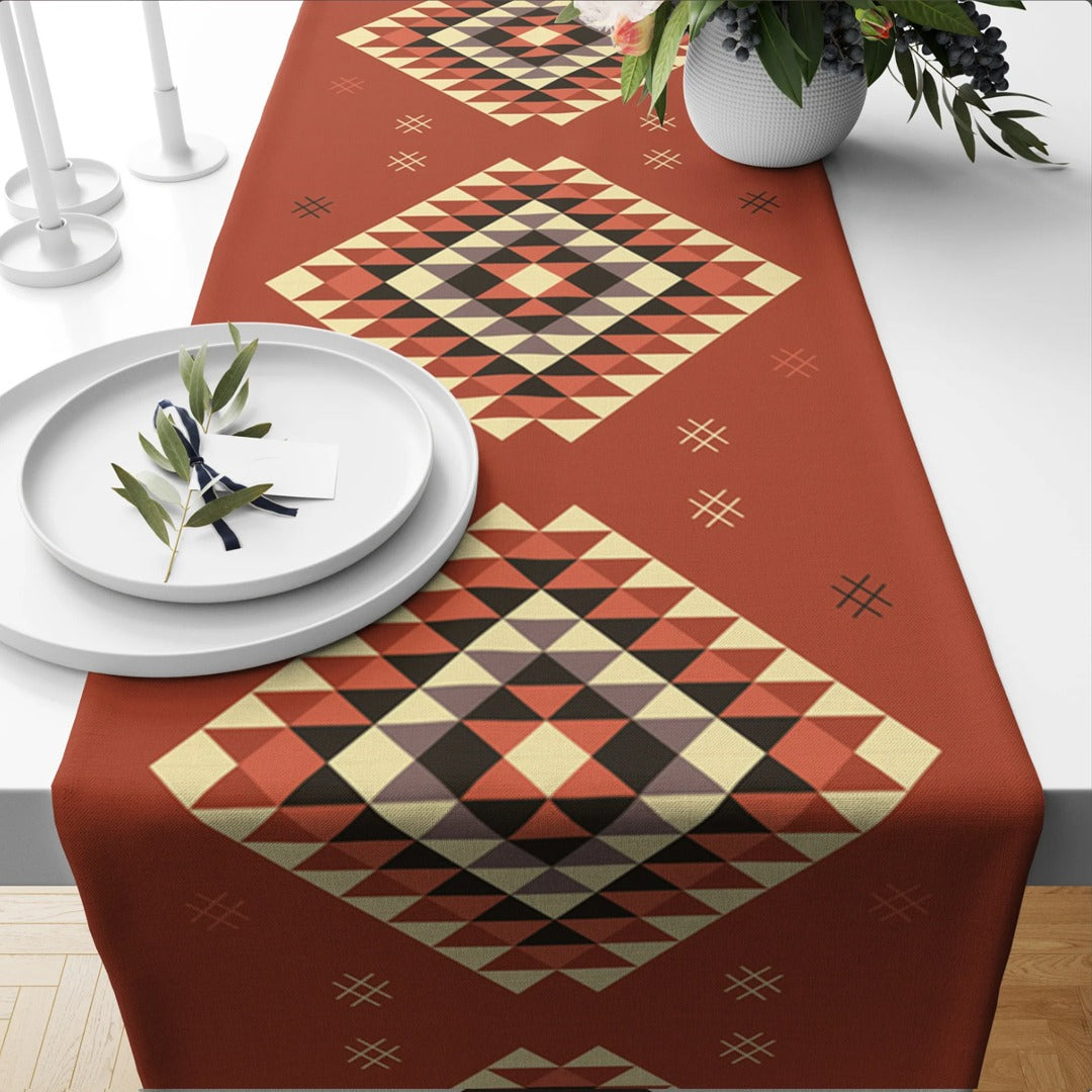 Rust-coloured table runner with multicoloured geometric diamond motifs.