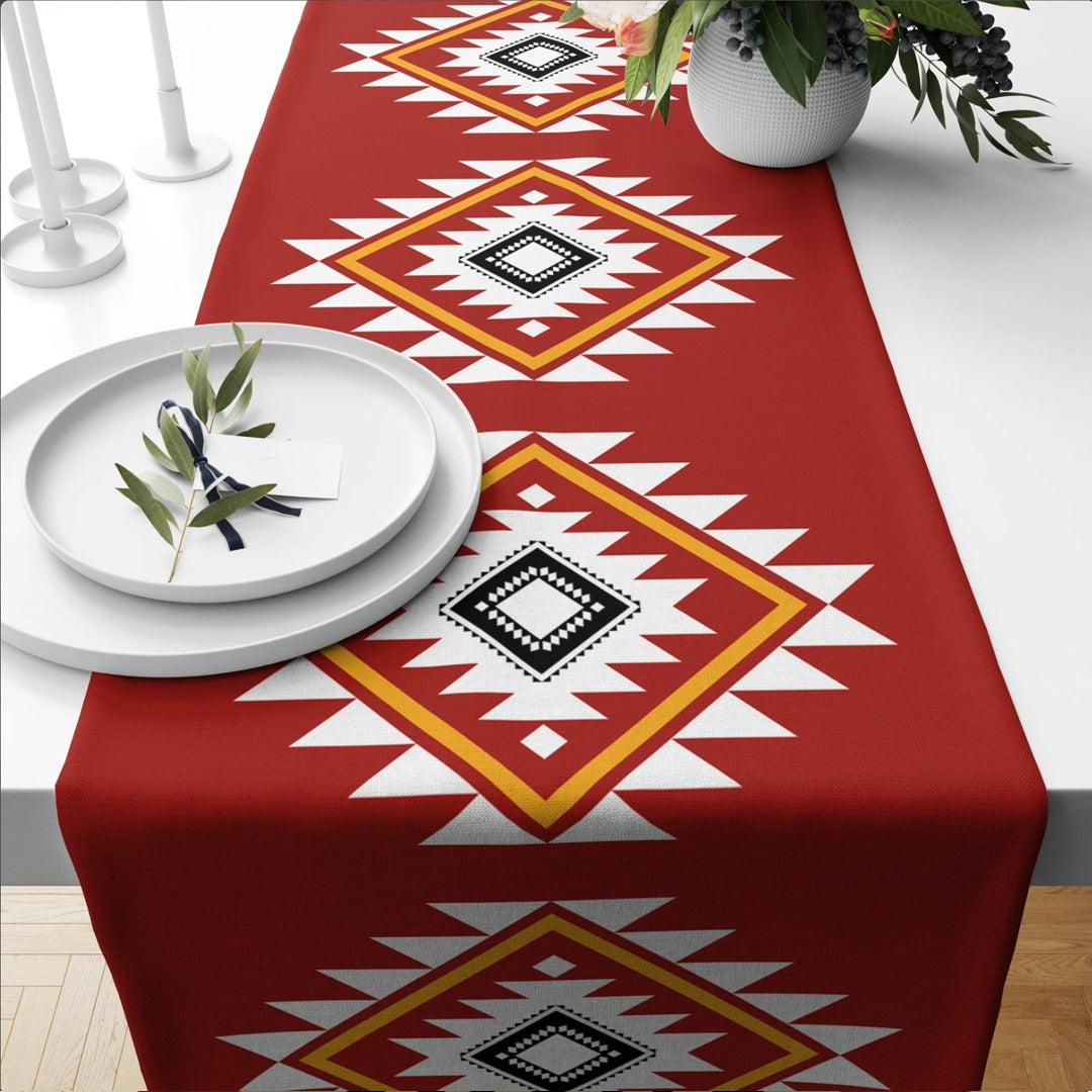 Red table runner with cream and black geometric diamond motifs.