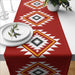 Red table runner with cream and black geometric diamond motifs.