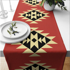 Terracotta table runner with large cream and black geometric star motifs.
