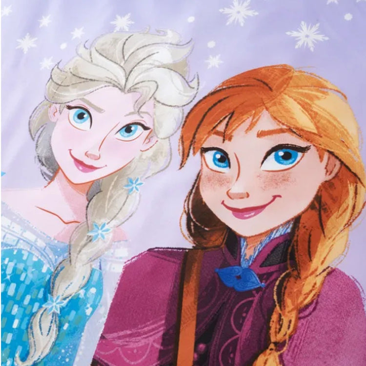 Close-up of two animated princesses on lilac bedsheet fabric.