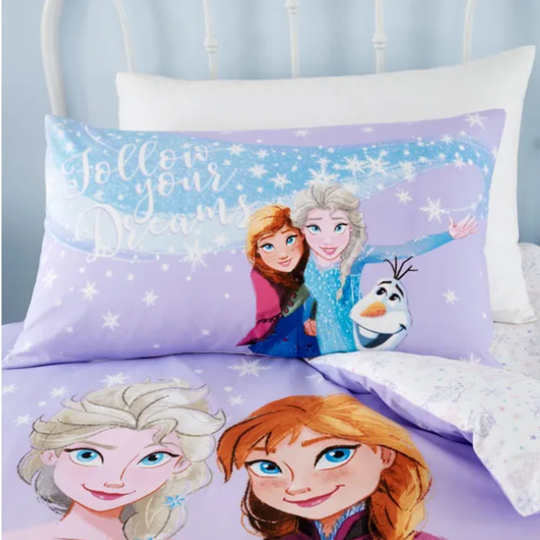 Close-up of matching princess-print pillowcases and a children's bedsheet.