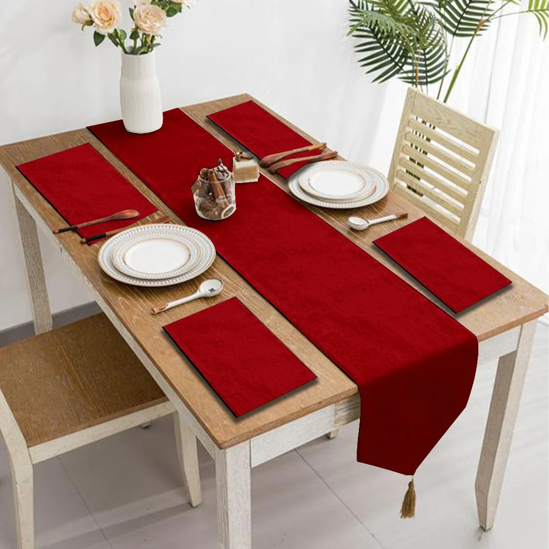 Red velvet table runner with matching red placemats.