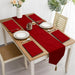Red velvet table runner with matching red placemats.