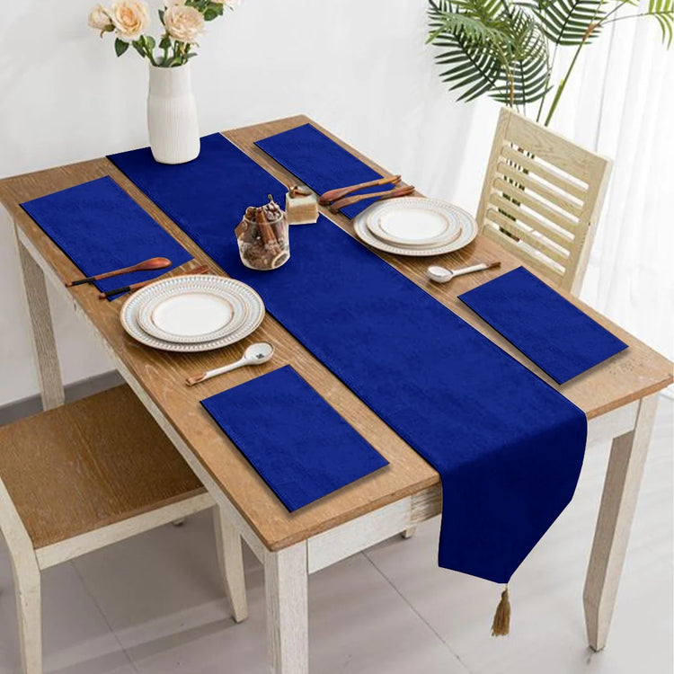 Royal blue velvet table runner with matching blue placemats.