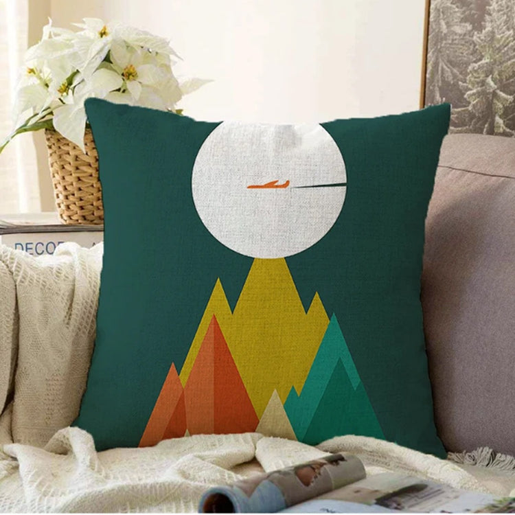 Dark green cushion cover with a large pale moon above colourful pointed mountains.