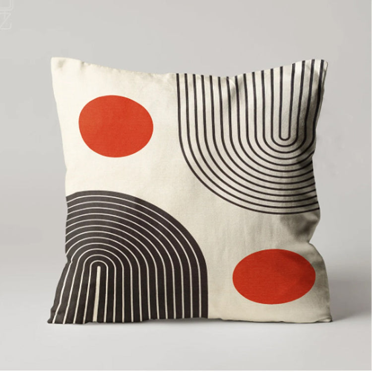 Cream cushion cover with two orange circles and curved black line patterns.