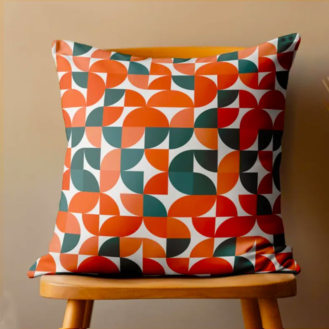 Cushion cover with orange, teal, cream and brown quarter-circle shapes.