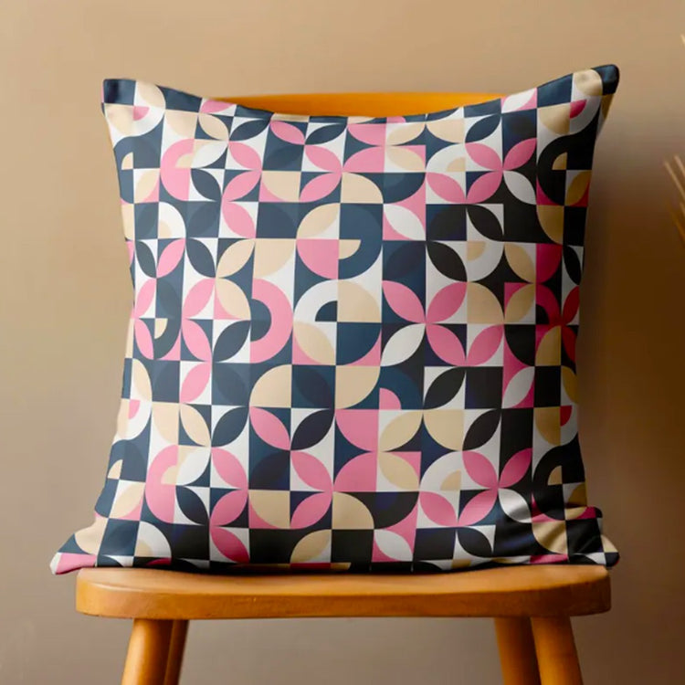 Cushion cover with pink, navy and cream quarter-circle geometric shapes.