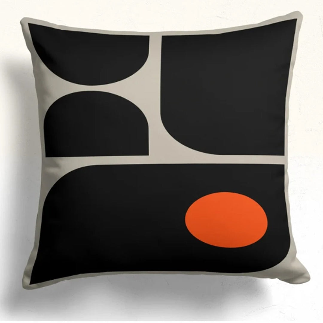 Cushion cover with rounded black panels divided by cream lines and an orange lower circle.