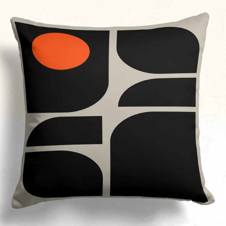 Cushion cover with curved black shapes divided by cream lines and an orange upper circle.
