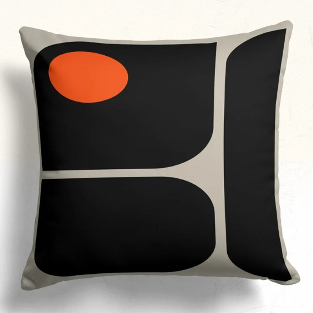 Cushion cover with rounded black panels, cream dividing lines and an orange circle at the upper left.