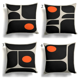 Four black and cream abstract cushion covers with orange circle accents.