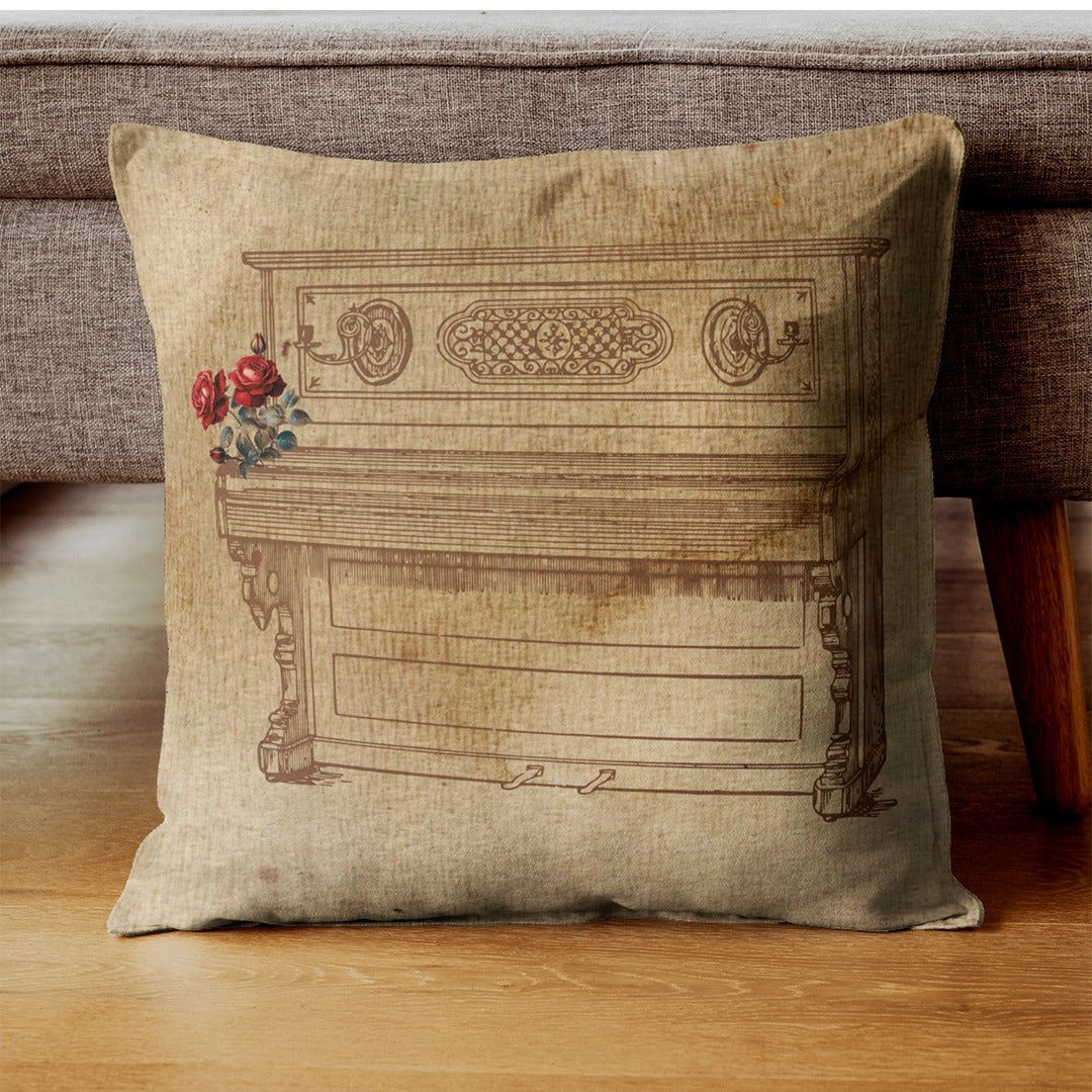 Beige cushion cover with a vintage piano illustration and red rose accents.
