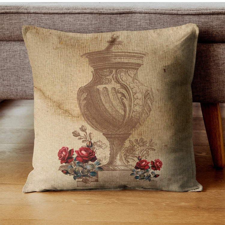 Beige cushion cover with an ornate urn illustration and red rose accents.