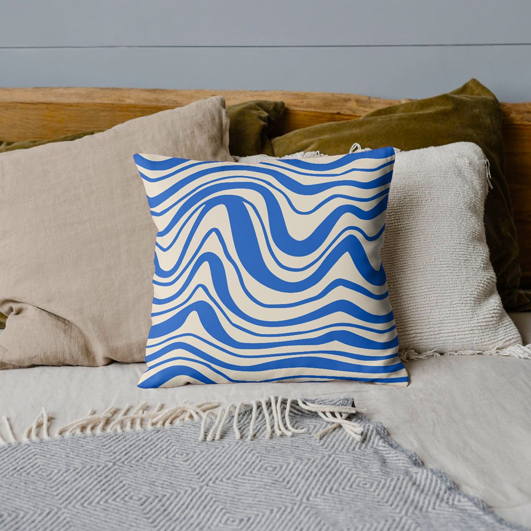 Cream cushion cover with flowing blue wavy stripes.