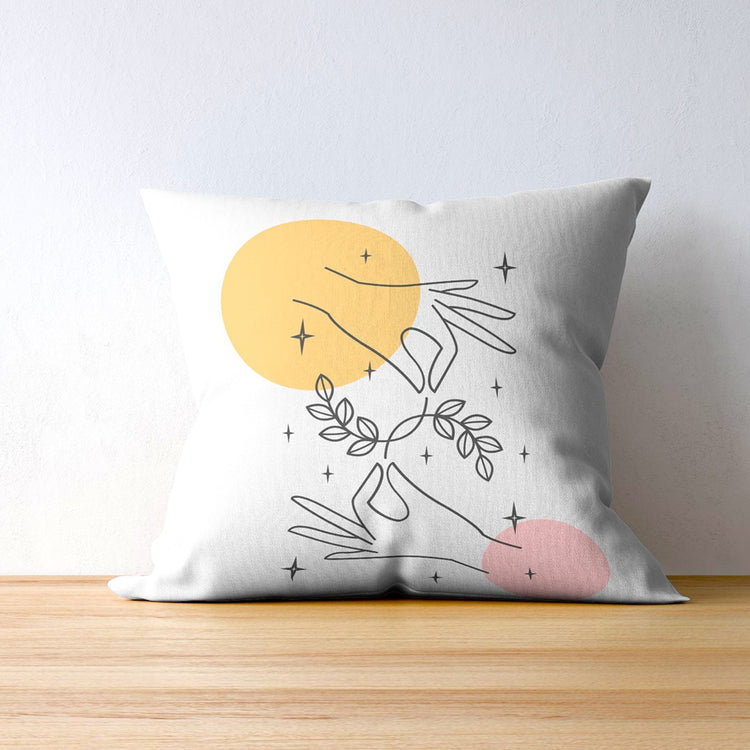 White cushion cover with fine leafy outlines and yellow and pink circles.