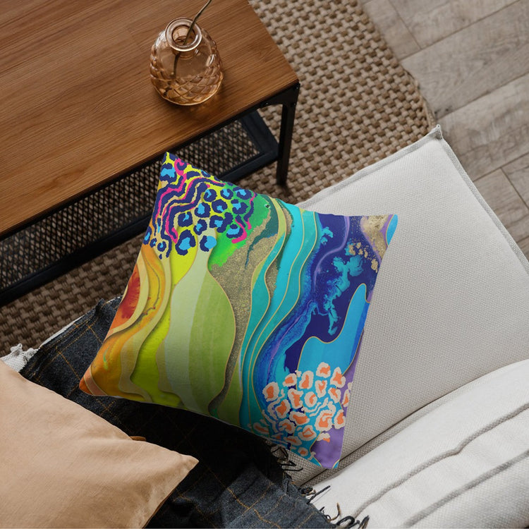 Cushion cover with flowing green, blue and purple shapes and colourful spotted details.