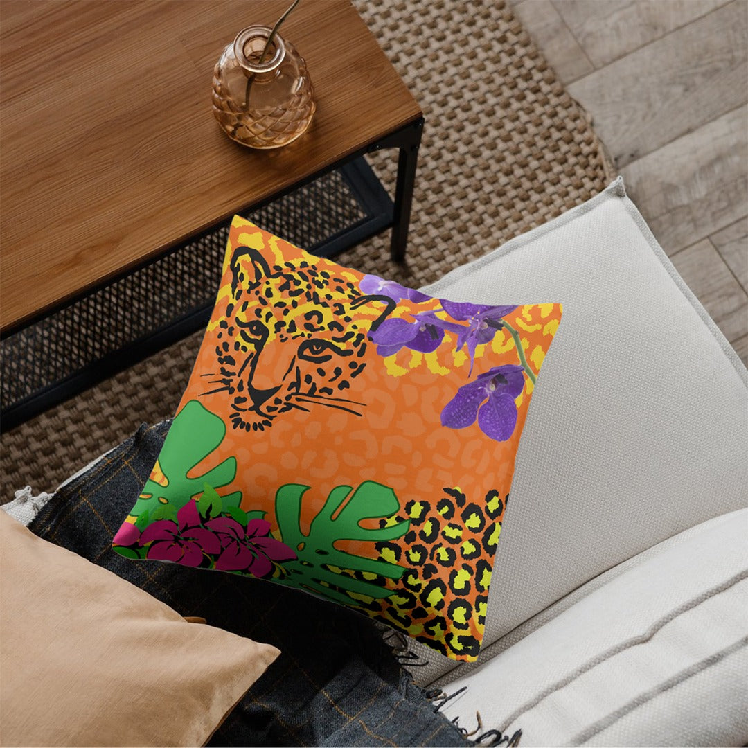 Orange cushion cover with colourful leaves and spotted animal-print panels.