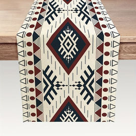 Overhead view of a cream, black and rust geometric diamond-pattern table runner.
