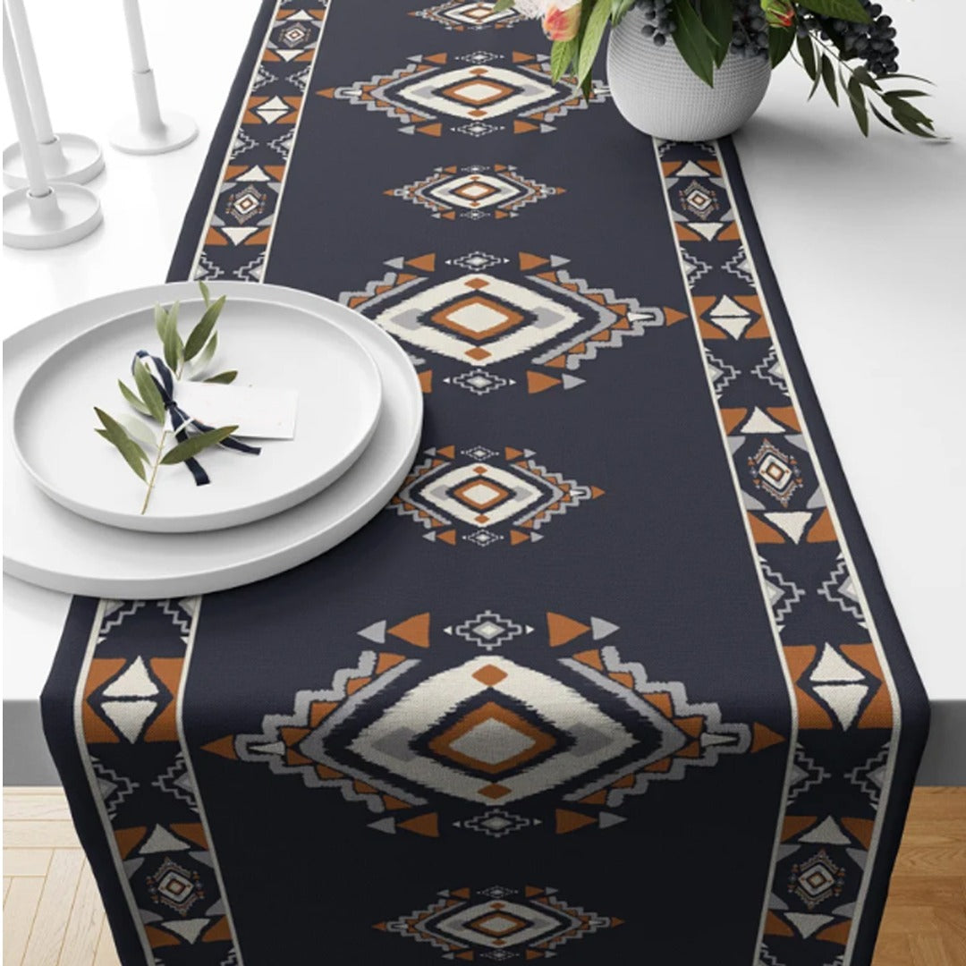 Navy table runner with cream and rust geometric diamond motifs.