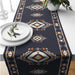 Navy table runner with cream and rust geometric diamond motifs.