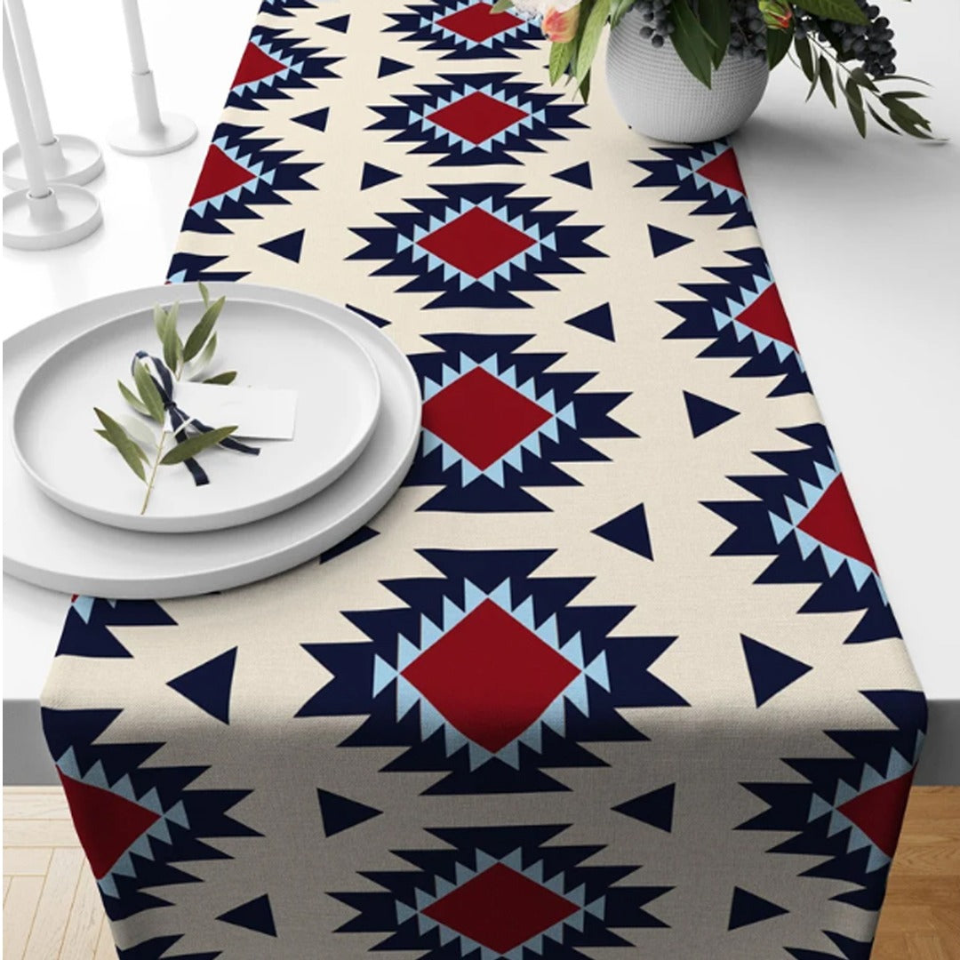 Cream table runner with navy geometric motifs and red diamond accents.