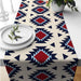 Cream table runner with navy geometric motifs and red diamond accents.