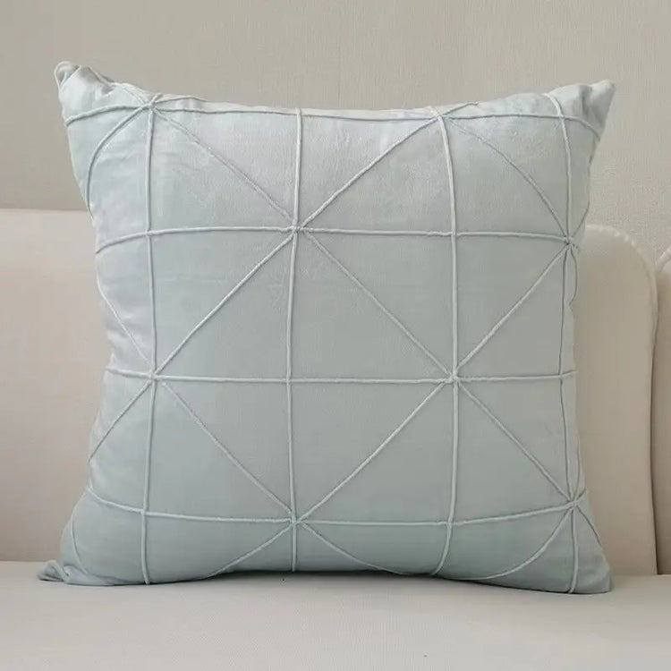 Pale blue cushion cover with intersecting geometric stitched lines.