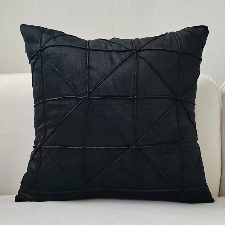 Black cushion cover with intersecting geometric stitched lines.