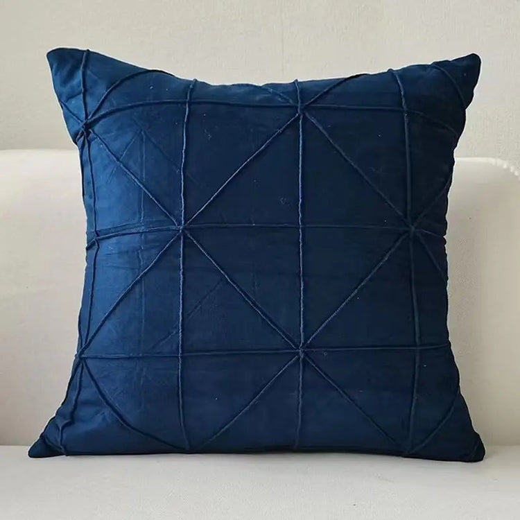 Navy cushion cover with intersecting geometric stitched lines.