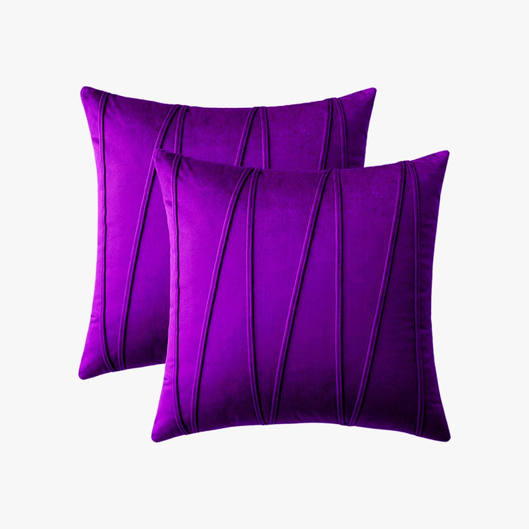 Two purple cushion covers with long angular stitched lines.