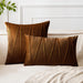 Brown square and rectangular cushion covers with angular stitched lines on a bed.