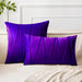 Purple square and rectangular cushion covers with angular stitched lines on a bed.