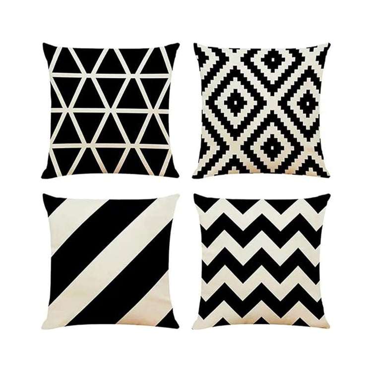 Four black and cream cushion covers with triangles, diamonds, diagonal stripes and zigzags.