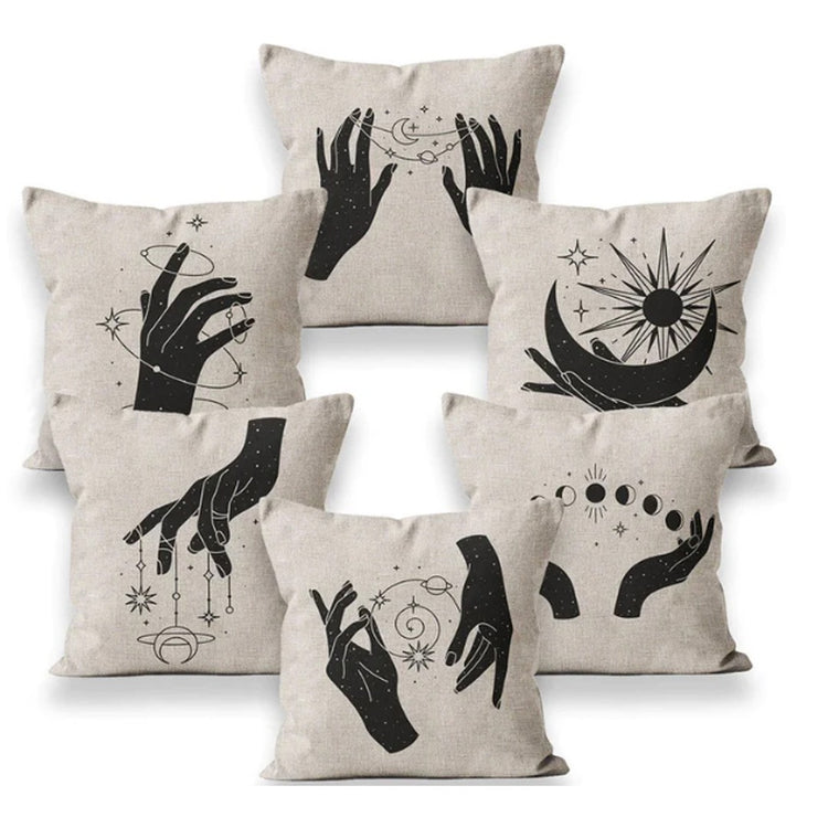 Six beige cushion covers with black hand illustrations and celestial symbols.