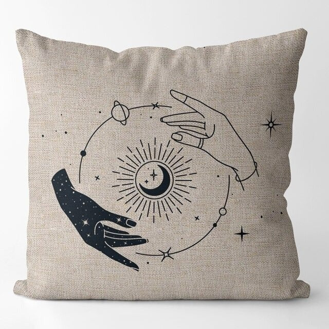 Beige cushion cover with two hands around a radiant eye and small stars.