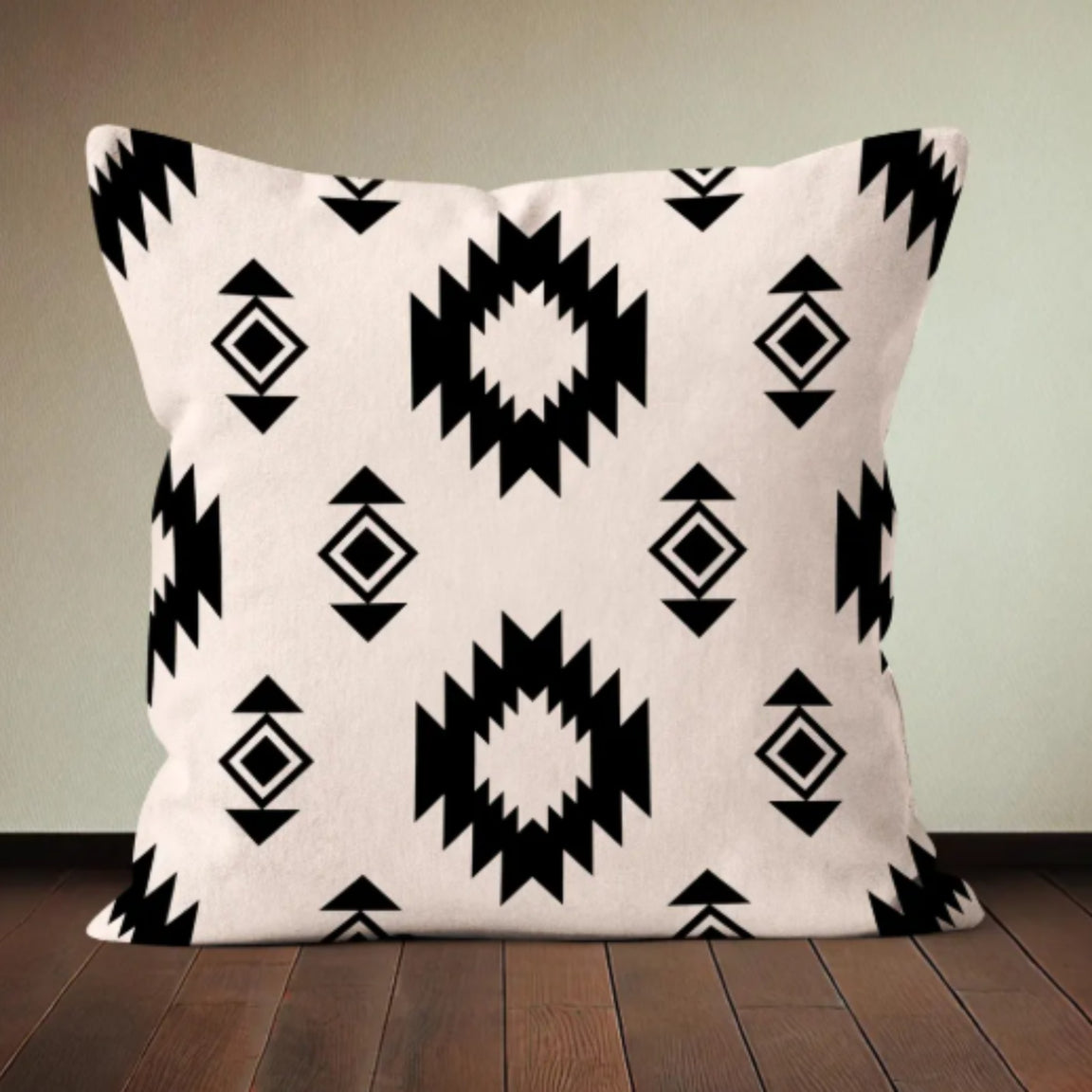 Cream cushion cover with repeating black stepped diamonds and smaller motifs.