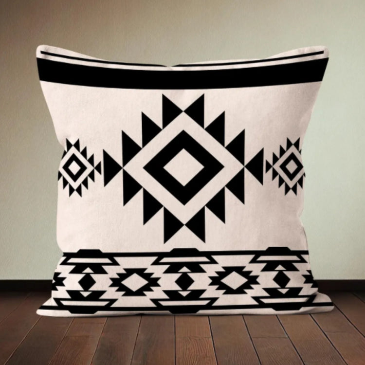 Cream cushion cover with a black central diamond and geometric border bands.