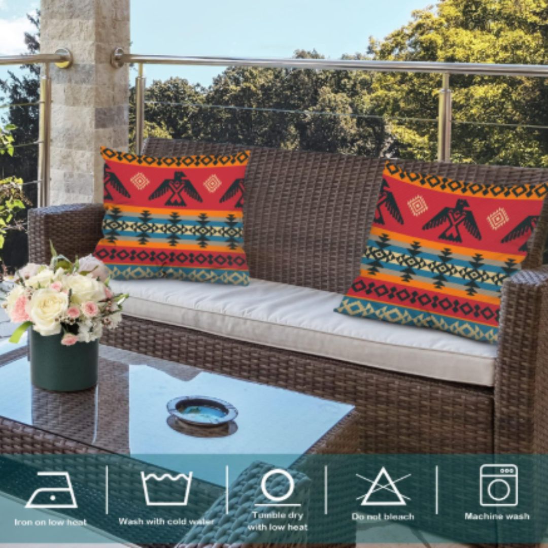 Two colourful red geometric cushion covers arranged on a woven outdoor sofa.