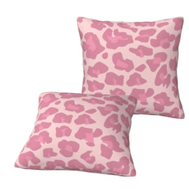 Two pale pink cushion covers with darker pink irregular animal-print spots.
