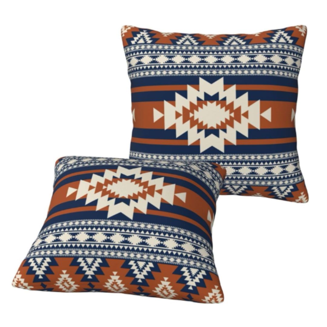 Two navy, rust and cream geometric cushion covers shown upright and lying flat.