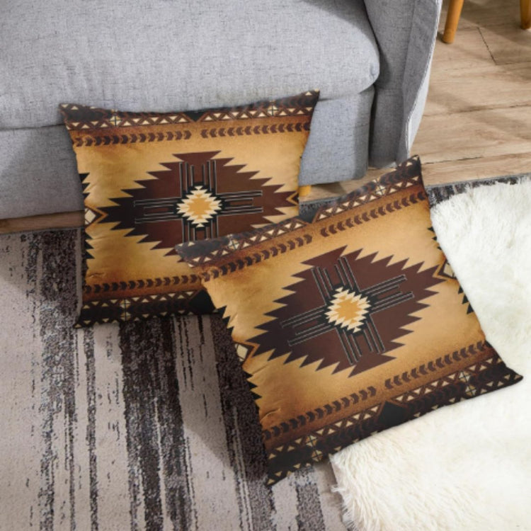 Two ochre cushion covers with dark brown stepped diamonds beside a gray sofa