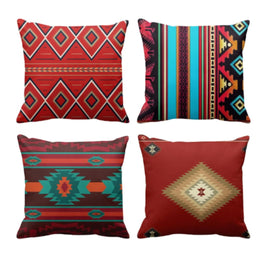 Four cushion covers with red, teal and multicoloured stripes and diamond motifs.