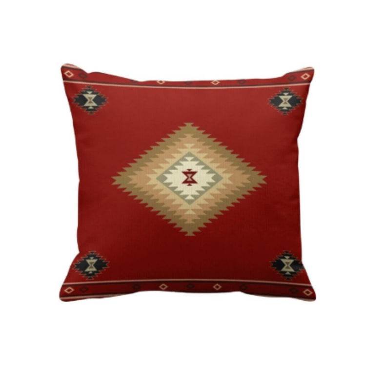 Rust red cushion cover with a small central cream stepped diamond and corner motifs.
