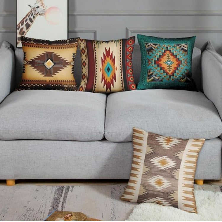 Four earthy geometric cushion covers displayed on a grey sofa and floor.